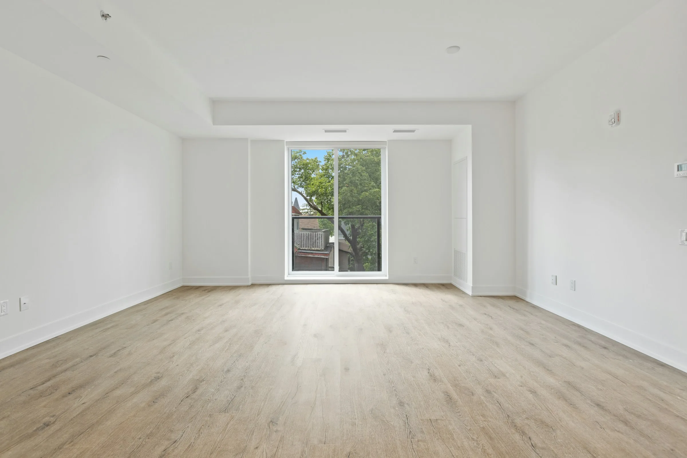 Empty white living room before and after virtual staging with neutral furniture before